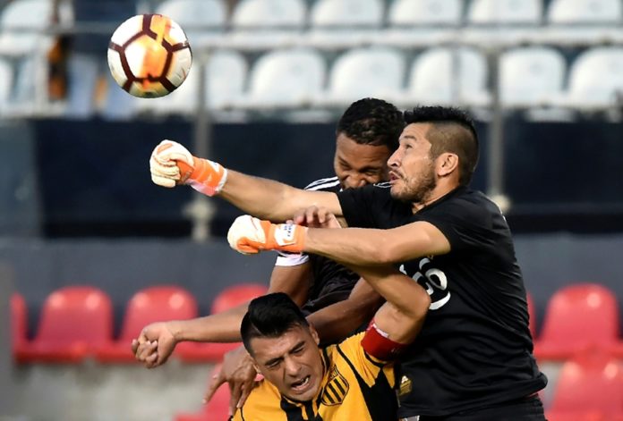 El portero paraguayo Víctor Centurión (drcha.), entonces jugador de Guaraní despeja un balón en un partido de la Copa Libertadores, en Asunción, el 6 de febrero de 2018. AFP